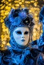 Venetian masks and costumes and bokeh effect.