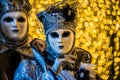 Venetian masks and costumes and bokeh effect.