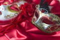 Venetian masks decorated by crystal and flowers on red silk background
