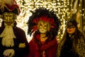 Venetian masks of a man and two women and bokeh effect.