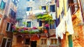 Venetian scenery with balconies with flowers and drying clothes and light graphic effect.