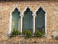 Venetian style windows in an old house. Background with eastern windows. Royalty Free Stock Photo