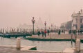 Venezia, Italy. Year 1983. Vintage photo of the dock close to San Marco square. Fall season. Foggy time