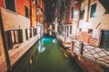 Venezia narrow channel and gondola boats in lagoon city Venice at night. Italy. Vivid colored old brick buildings street Royalty Free Stock Photo