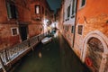 Venezia at night. Narrow channel and gondola boats in lagoon river city of venice. Long exposure photo Royalty Free Stock Photo