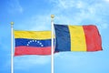 Venezuela and Chad two flags on flagpoles and blue sky