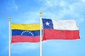 Venezuela and Chile two flags on flagpoles and blue sky