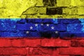 Venezuela flag on a brick wall background with broken plaster