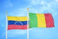 Venezuela and Mali two flags on flagpoles and blue sky