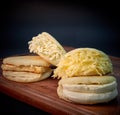 Venezuelan arepas filled with different types of cheese with wooden board