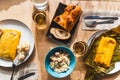 Venezuelan christmas food display on table with traditional hallacas, pan de jamon or ham bread, and mixed salad, with cutlery and Royalty Free Stock Photo