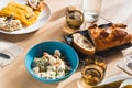 Venezuelan christmas food display on table with traditional hallacas, pan de jamon or ham bread, and mixed salad, with cutlery and Royalty Free Stock Photo