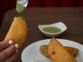 Venezuelan food empanada with guasacaca sauce