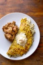 VENEZUELAN FOOD. Corn CACHAPA with cheese and fried pork - cochino frito. Wooden background, top view