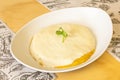 Venezuelan fried corn cachapa recipe topped with melted fresh cheese