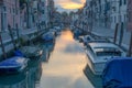 Venice canal with parked boats