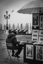 An ambulant painter selling his work on the streets of Venice city Royalty Free Stock Photo