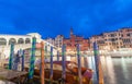 VENICE - APRIL 5, 2014: Tourists near Rialto Bridge at night. Venice is a famous tourist attraction in Europe Royalty Free Stock Photo