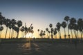 Venice beach Sunset in Los Angeles with a pedestrian walk during orange sunset. Empty beach