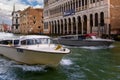 Venice boat transportation, Taxis and tours speed boats in one channel with typical architecture Royalty Free Stock Photo