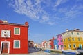 Burano island canal, small colored houses and the boats