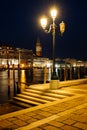 Venice canal with historical buildings and gondolas at night. Royalty Free Stock Photo