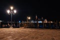 Venice canal with historical buildings and gondolas at night. Royalty Free Stock Photo