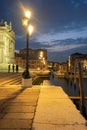 Venice canal with historical buildings and gondolas at night. Royalty Free Stock Photo