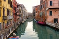 Venice canal with moored boats and colorful buildings