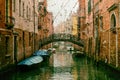 Venice canal with moored boats with a vintage effect