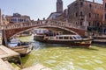 Vaporetto passing under a bridge over a canal in Venice in Veneto, Italy Royalty Free Stock Photo