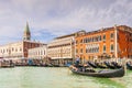 Riva degli Schiavoni, its facades and gondolas with tourists in Venice in Veneto, Italy