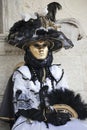 Venice Carnival character dressed in a colourful black and white costume and venetian mask Venice Italy Royalty Free Stock Photo