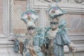 Two people in Venice masks dressed in turquoise costumes at the Venice Carnival in Venice Italy