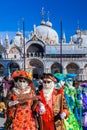 Venice with carnival masks against Mark`s Square in Italy Royalty Free Stock Photo