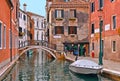 Venice colorful corners, old buildings and windows, people, water canal with reflections, boats and small bridge , Ita