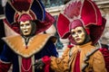 Venice - February 6, 2016: Colourful carnival mask through the streets of Venice