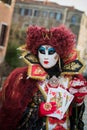 Venice - February 6, 2016: Colourful carnival mask through the streets of Venice