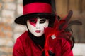 Venice - February 6, 2016: Colourful carnival mask through the streets of Venice