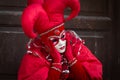 Venice - February 6, 2016: Colourful carnival mask through the streets of Venice