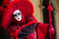 VENICE, FEBRUARY 10: An unidentified woman in typical red dress poses during traditional Venice Carnival