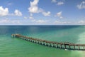 Venice fishing pier in Florida on sunny summer day. Bright seascape with surf waves crashing on sandy beach Royalty Free Stock Photo