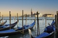 Venice gondola moored with San Marco Maggiore church i