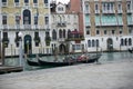 Venice gondolas at rest, behind Rialto market and trattorie, lunchtime, winter