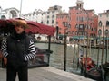 Venice, gondolier, waiting for passengers on the dock by Rialto bridge Royalty Free Stock Photo