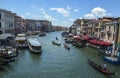 Venice grand canal or Canal Grande, with gondolas, boats, and colorful houses in summer bright day Royalty Free Stock Photo