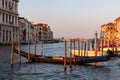 Venice - Group of gondolas moored in Grand Canale during sunset with scenic view of water channel