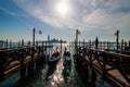 Venice italian city view with gondolas parked at seashore, channels and bridges, sea and clouds sky landscape at sunny day in Ital Royalty Free Stock Photo