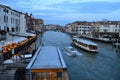 Beautiful sunset over the Grand Canal in Venice near the Railway station with a view to a ferry pier and restaurants. Royalty Free Stock Photo