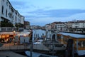 Beautiful sunset over the Grand Canal in Venice near the Railway station with a view to a ferry pier and restaurants. Royalty Free Stock Photo